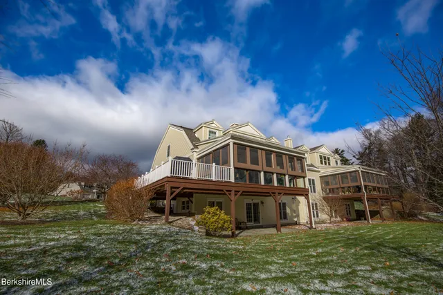 a view of a brick house with many windows and a table