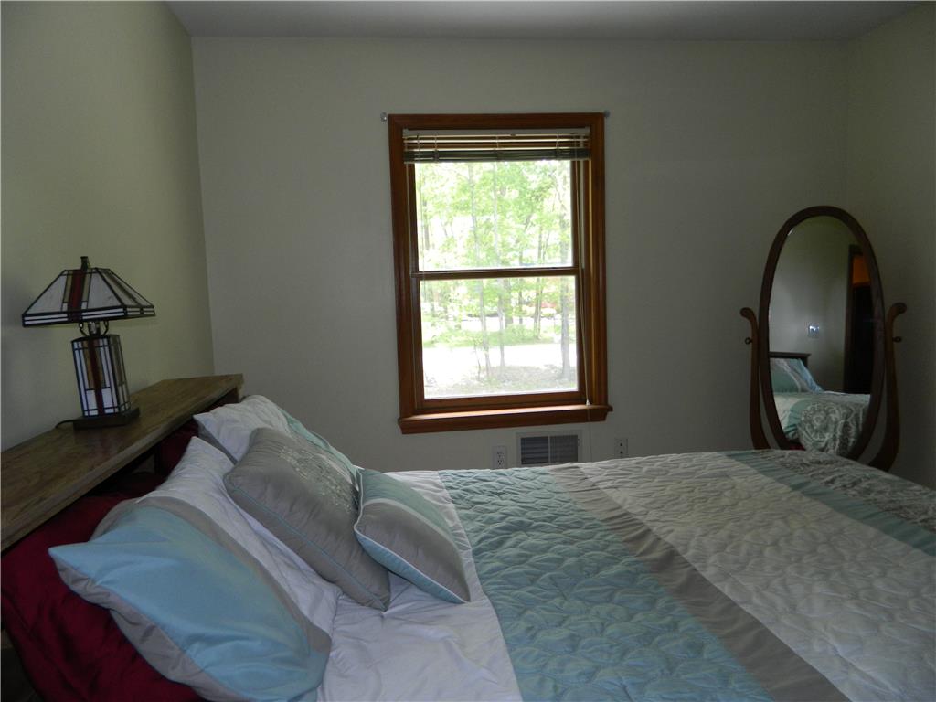 328 Pin Oak Road Stroudsburg, PA 18360 - Photo 32 of 37 Natural light filters through the window into this comfortable bedroom retreat.