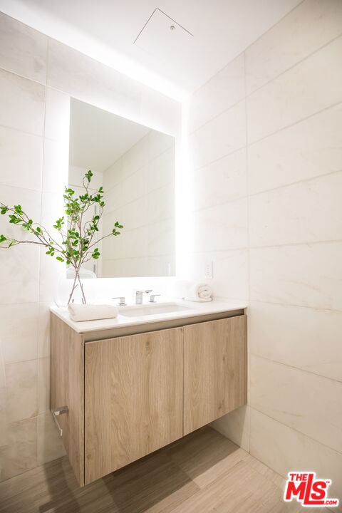 8600 Wilshire Boulevard, Unit GF15 Beverly Hills, CA 90211 - Photo 11 of 26 a bathroom with a sink and a mirror