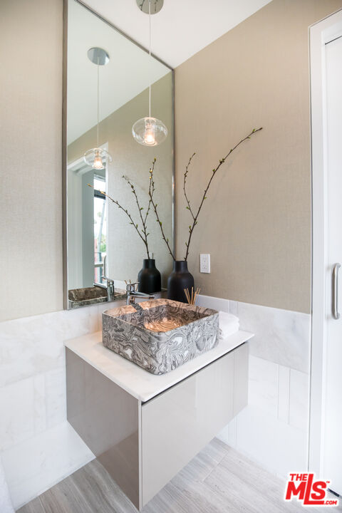 8600 Wilshire Boulevard, Unit GF15 Beverly Hills, CA 90211 - Photo 14 of 26 a bathroom with a sink and a mirror