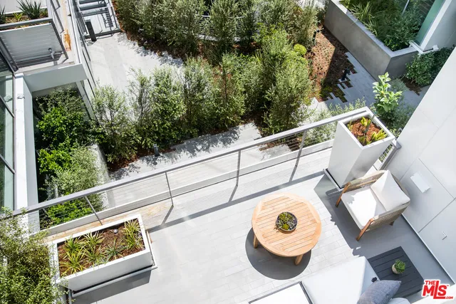 a living room with furniture a flat screen tv and floor to ceiling window