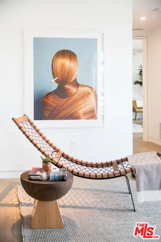 a living room with a couch and a potted plant