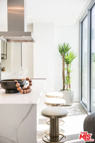 a bathroom with a sink a mirror and a potted plant