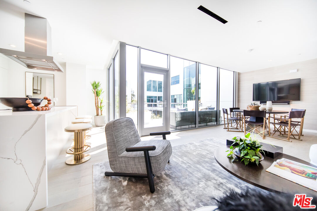 8600 Wilshire Boulevard, Unit GF15 Beverly Hills, CA 90211 - Photo 4 of 26 a living room with furniture and a potted plant