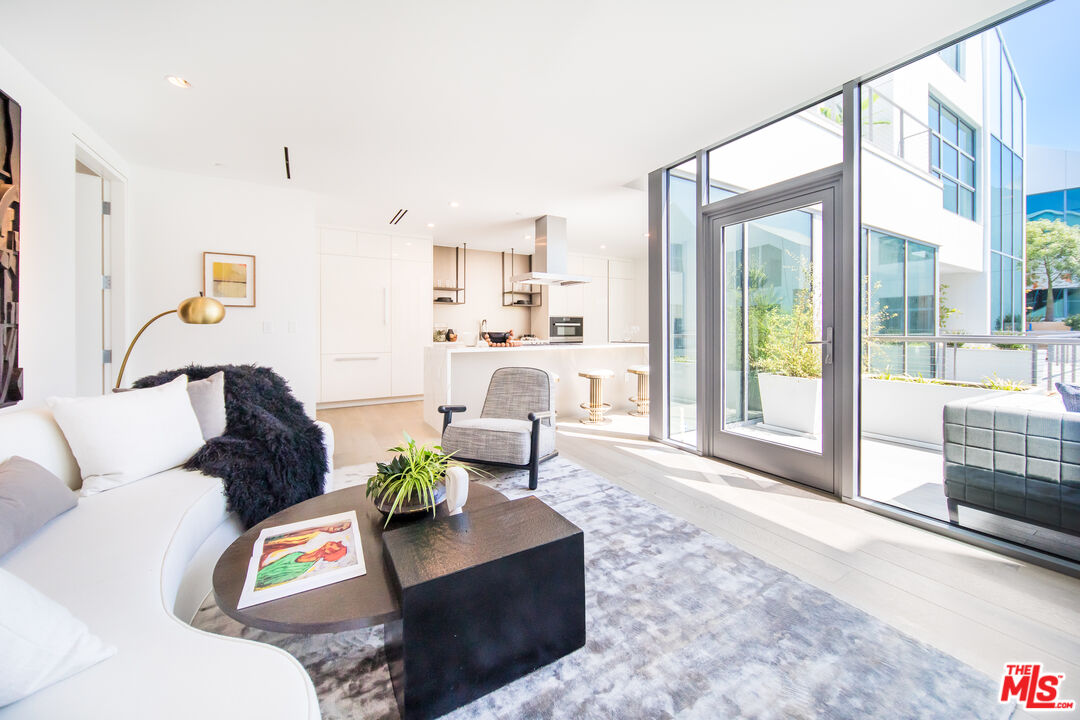 8600 Wilshire Boulevard, Unit GF15 Beverly Hills, CA 90211 - Photo 5 of 26 a living room with furniture and a large window