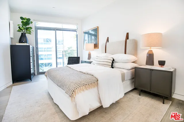 a bedroom with bed and window