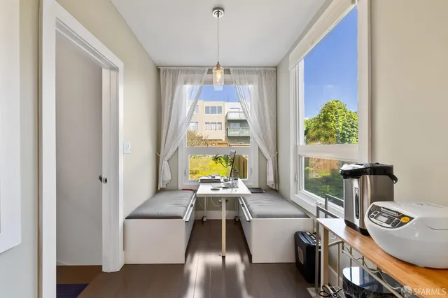 a bedroom with two beds and painting on the wall