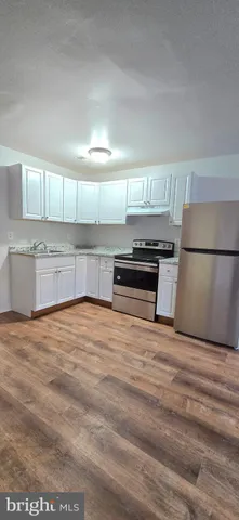 a view of kitchen with cabinets and wooden floor