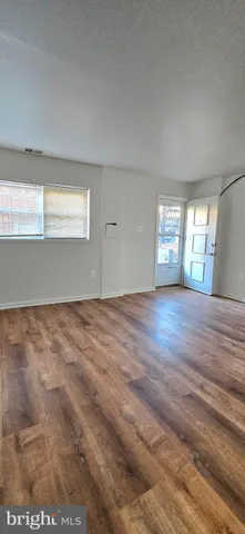 a view of wooden floor and windows in a room