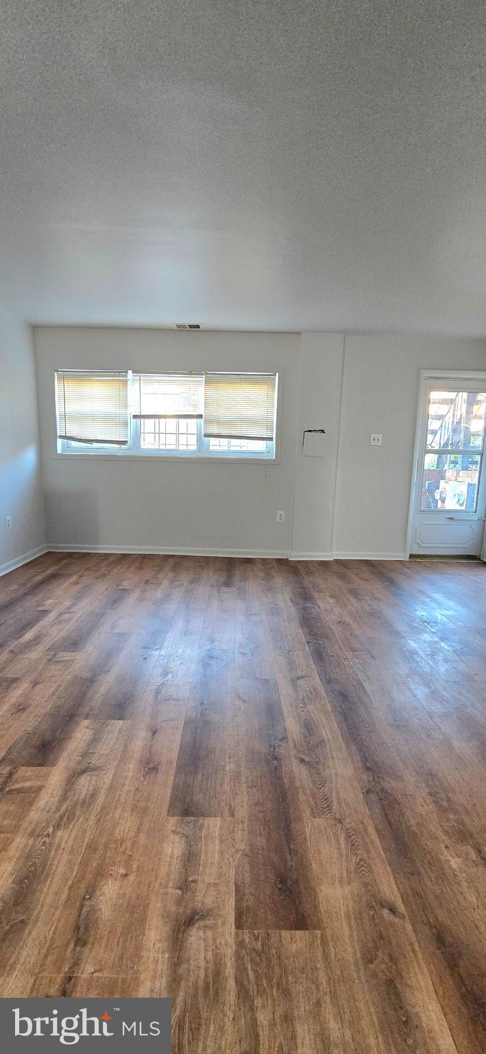 4641 6th Street Southeast Washington, DC 20032 - Photo 5 of 6 an empty room with wooden floor and windows