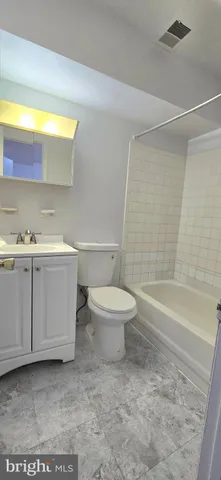 a bathroom with a toilet a sink and bathtub