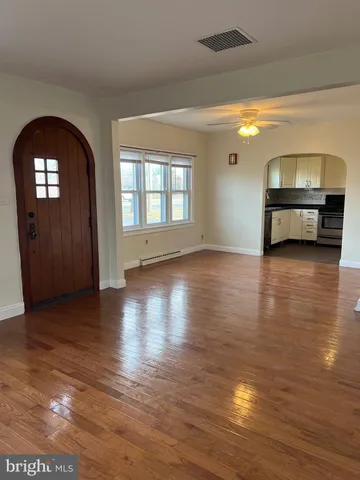 a view of room with window and wooden floor