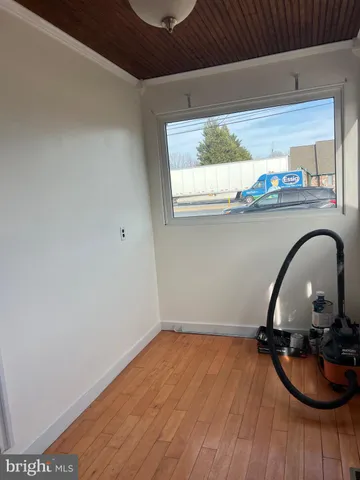 a room with wooden floor and window