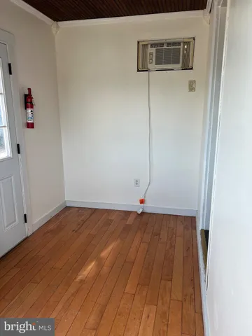 a view of a room with wooden floor
