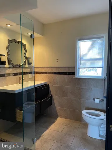 a bathroom with a toilet a sink and window