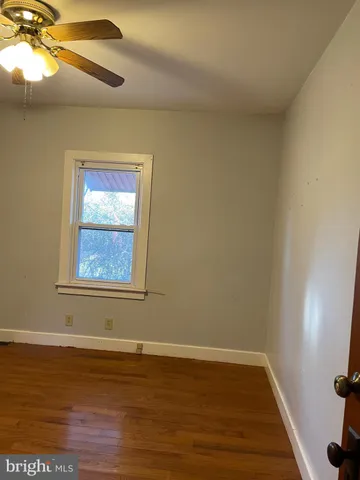 a view of an empty room and wooden floor