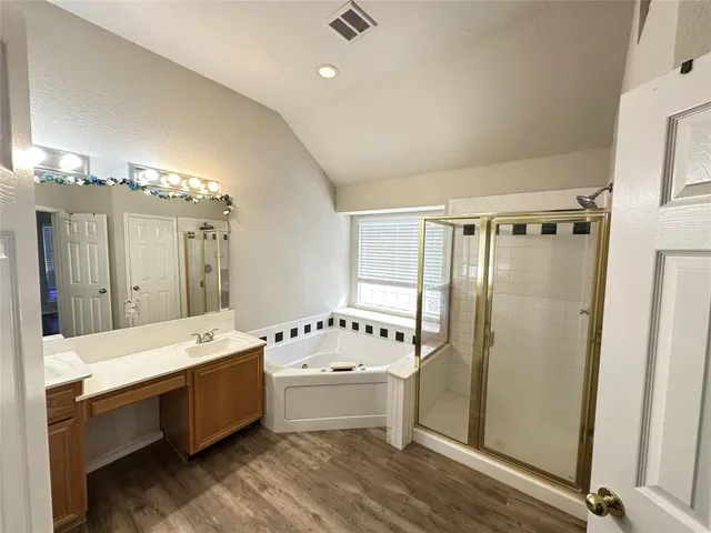 a bathroom with a tub a sink and mirrors