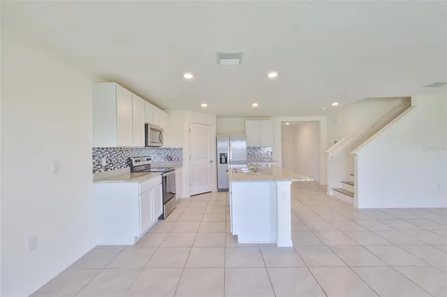 a kitchen with a sink and white cabinets