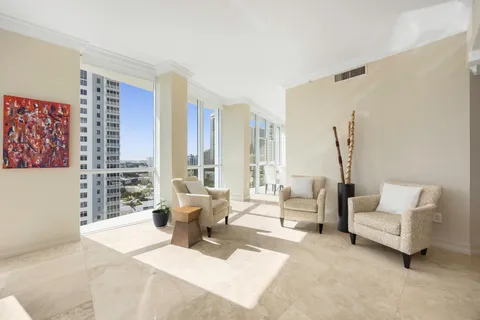 a living room with furniture and large windows