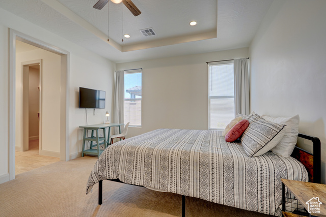 1329 Paseos Street Washington, UT 84780 - Photo 16 of 35 Bedroom featuring light colored carpet, recessed lighting, a tray ceiling, and a ceiling fan
