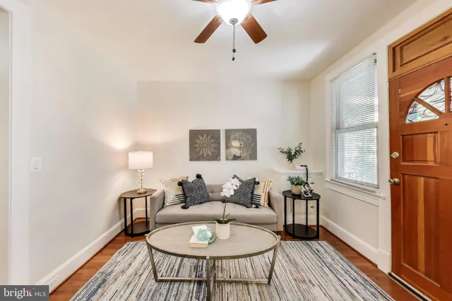 a living room with furniture a window and a table
