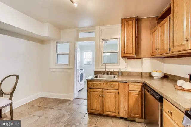 a kitchen with stainless steel appliances granite countertop a sink and cabinets