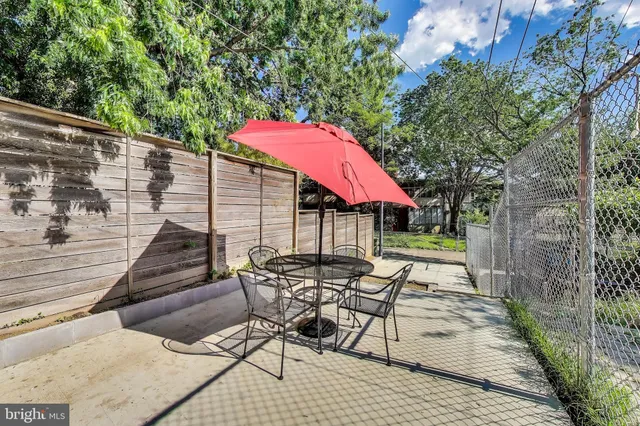 a patio with tables and chairs