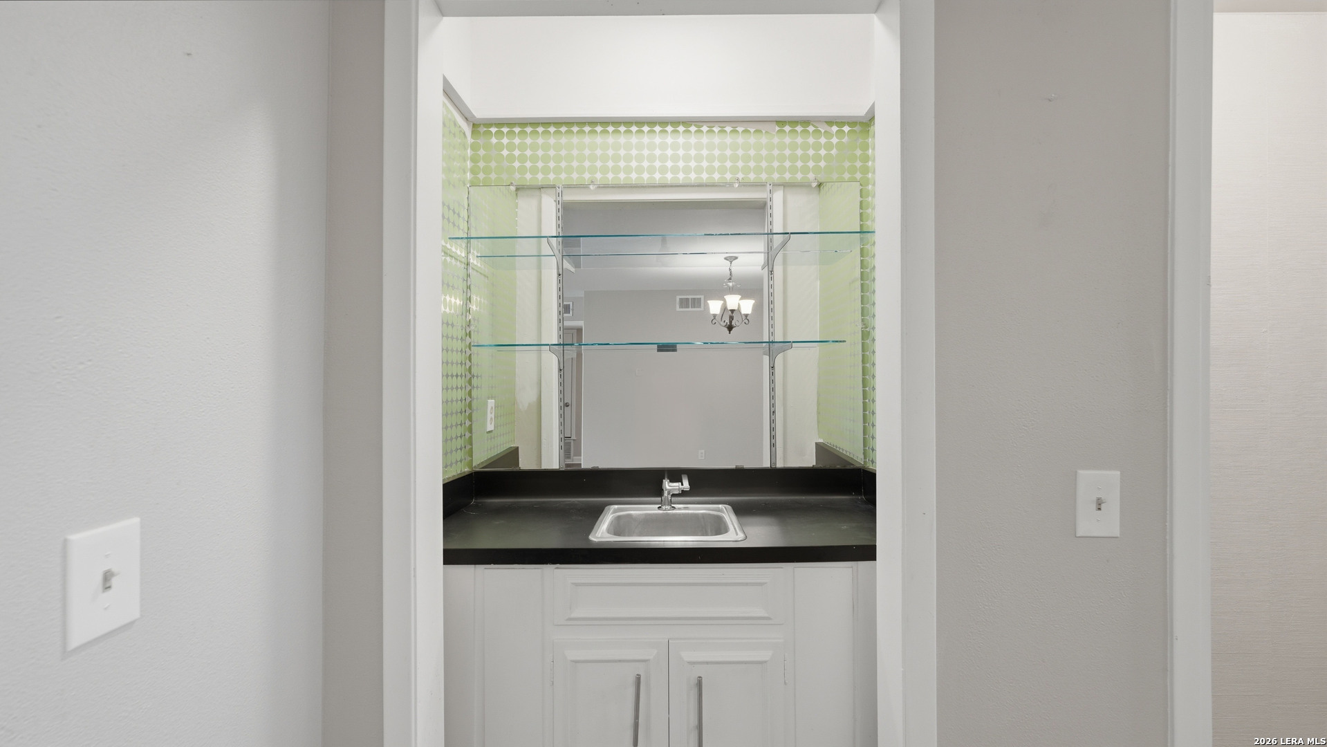 7500 Callaghan Road, Unit 140 San Antonio, TX 78229 - Photo 11 of 42 a bathroom with a granite countertop sink and a mirror