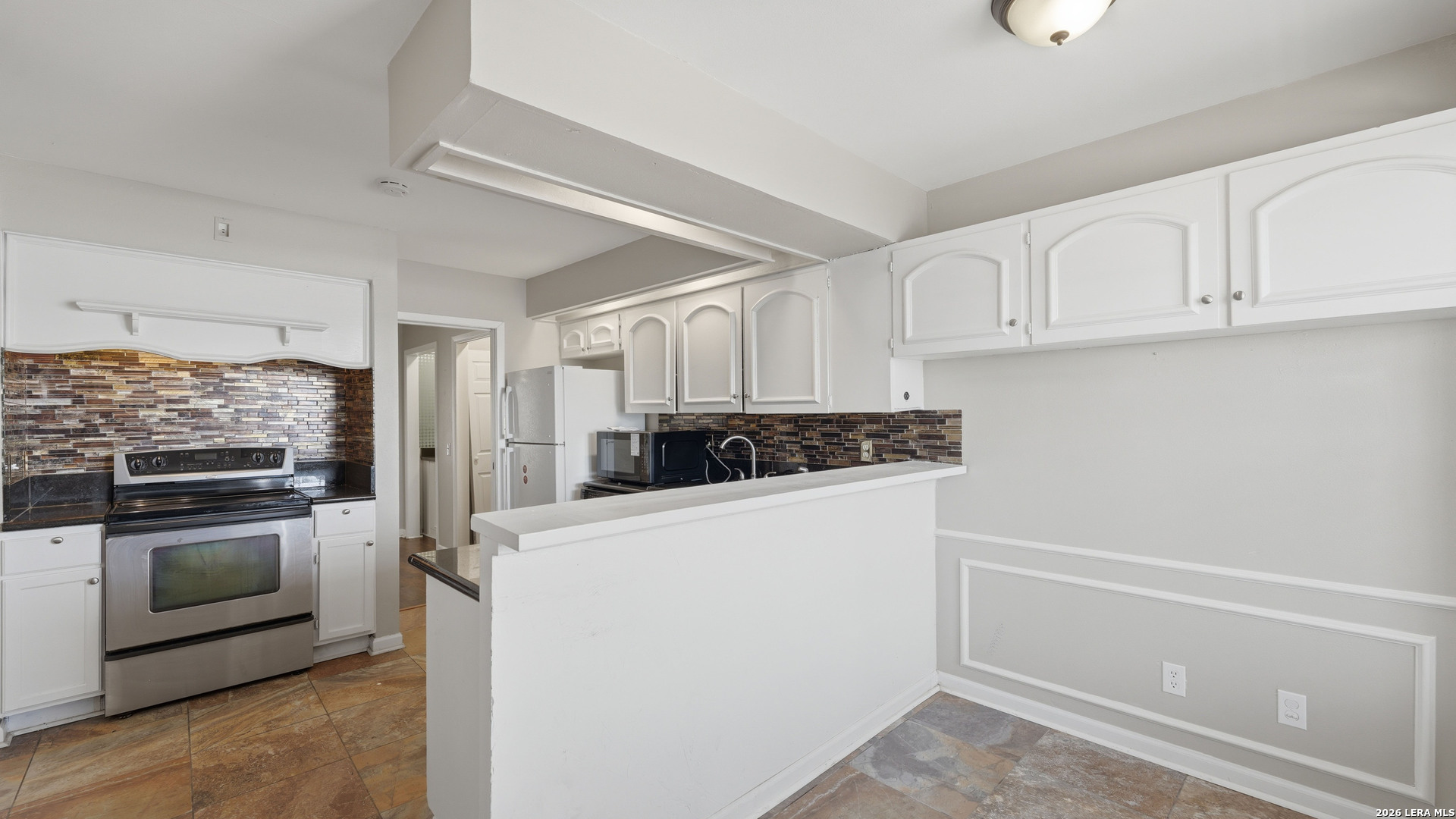 7500 Callaghan Road, Unit 140 San Antonio, TX 78229 - Photo 12 of 42 a kitchen with a refrigerator sink and cabinets