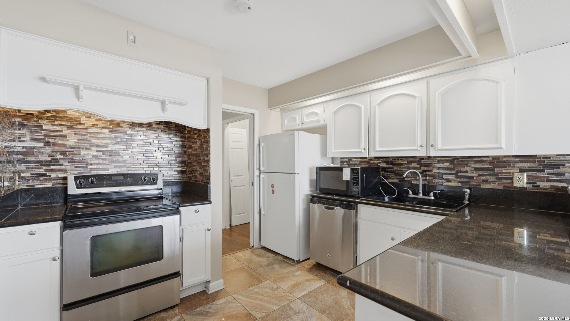 7500 Callaghan Road, Unit 140 San Antonio, TX 78229 - Photo 14 of 42 a kitchen with a stove and a microwave