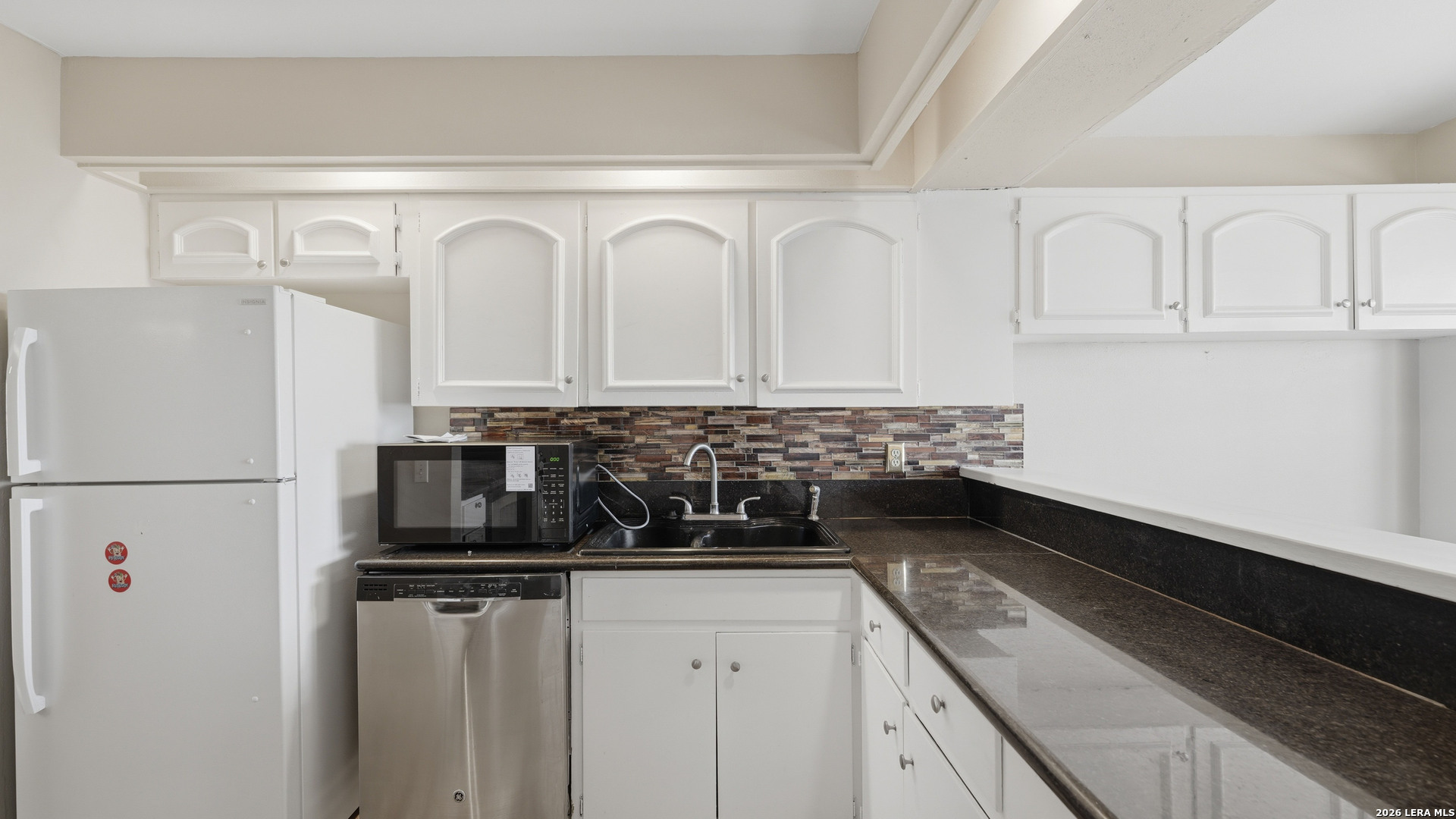 7500 Callaghan Road, Unit 140 San Antonio, TX 78229 - Photo 17 of 42 a kitchen with white cabinets and white appliances
