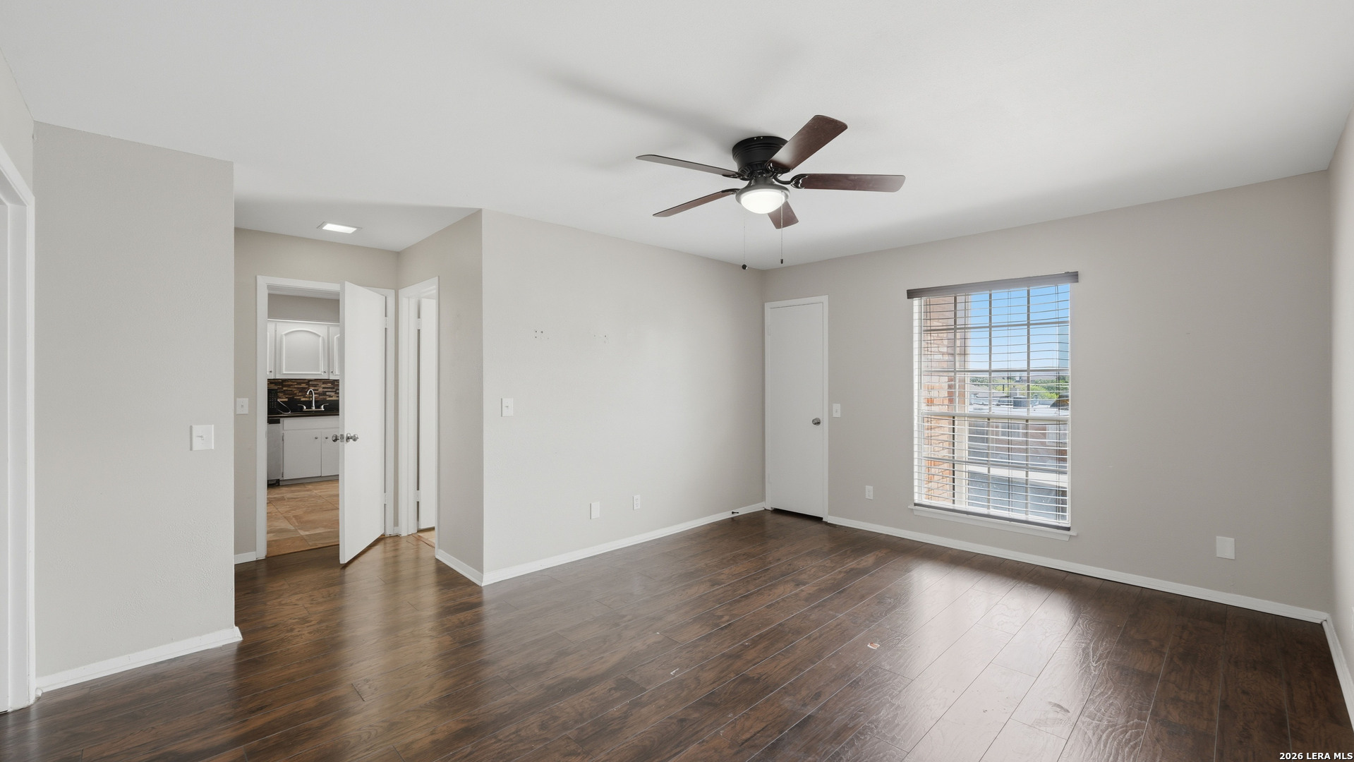 7500 Callaghan Road, Unit 140 San Antonio, TX 78229 - Photo 21 of 42 a view of empty room with wooden floor and fan
