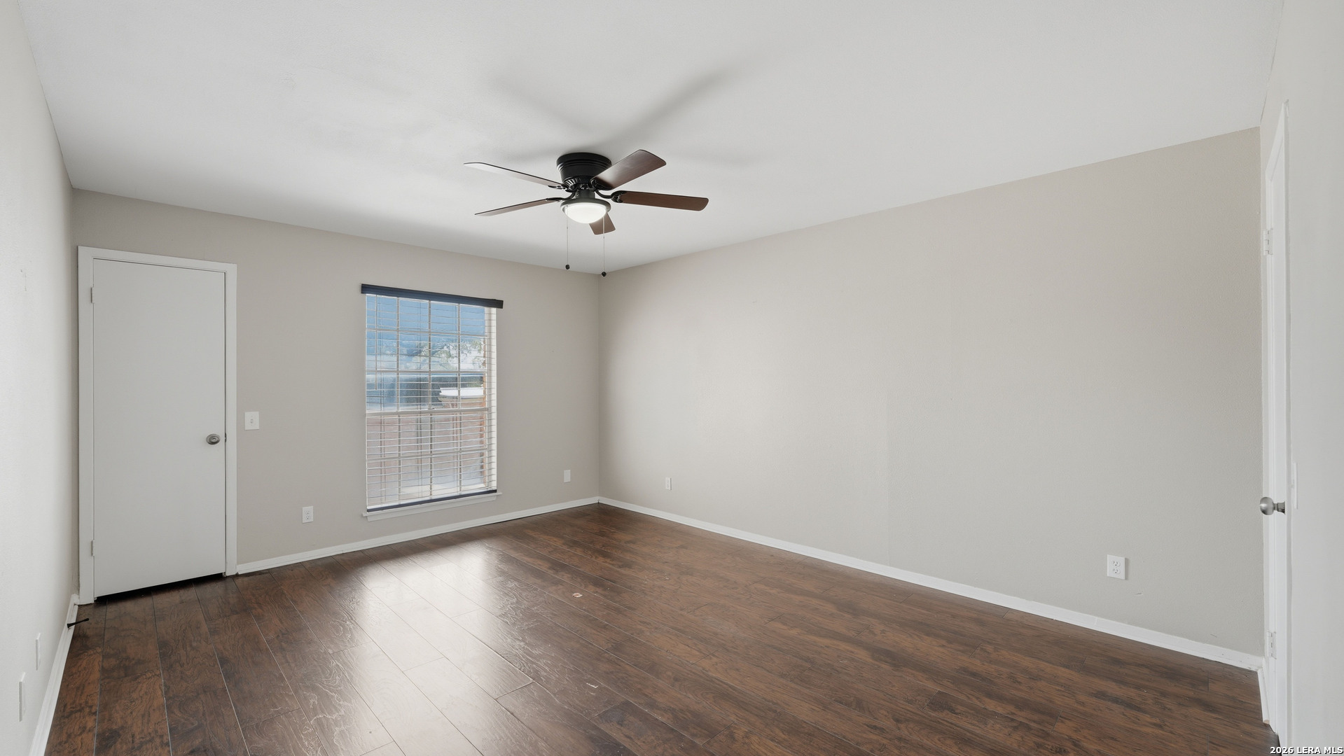 7500 Callaghan Road, Unit 140 San Antonio, TX 78229 - Photo 22 of 42 a view of empty room with wooden floor and fan