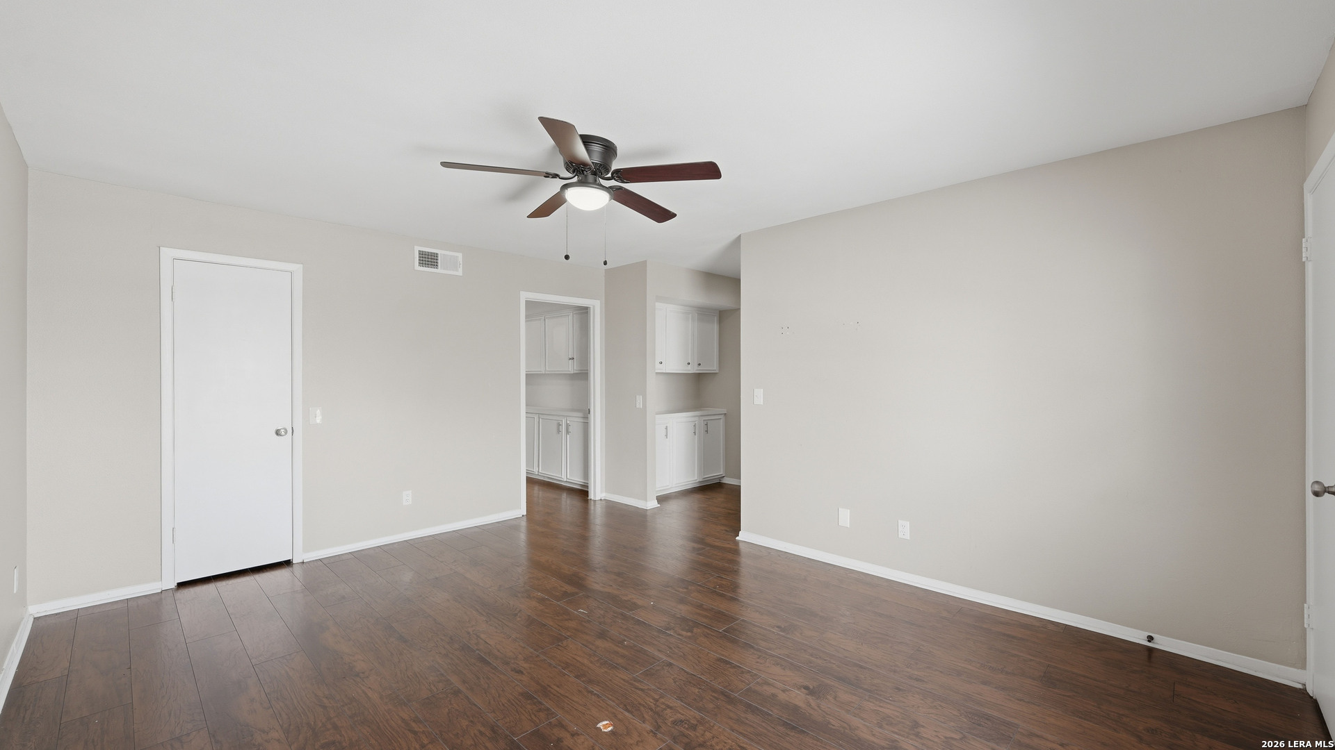 7500 Callaghan Road, Unit 140 San Antonio, TX 78229 - Photo 24 of 42 a view of empty room with wooden floor and ceiling fan
