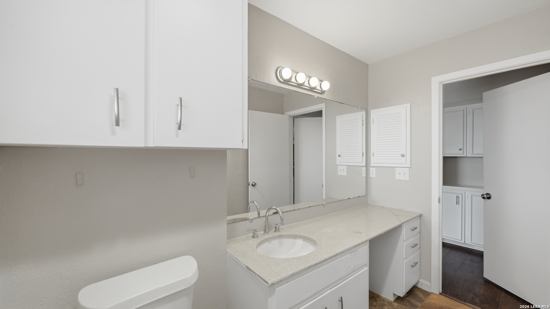7500 Callaghan Road, Unit 140 San Antonio, TX 78229 - Photo 26 of 42 a bathroom with a sink a toilet and mirror