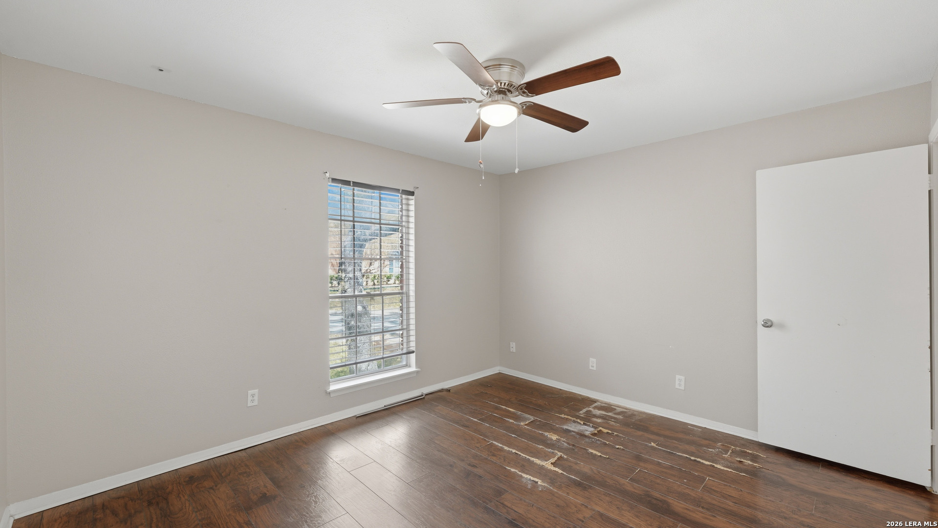 7500 Callaghan Road, Unit 140 San Antonio, TX 78229 - Photo 31 of 42 an empty room with wooden floor fan and windows