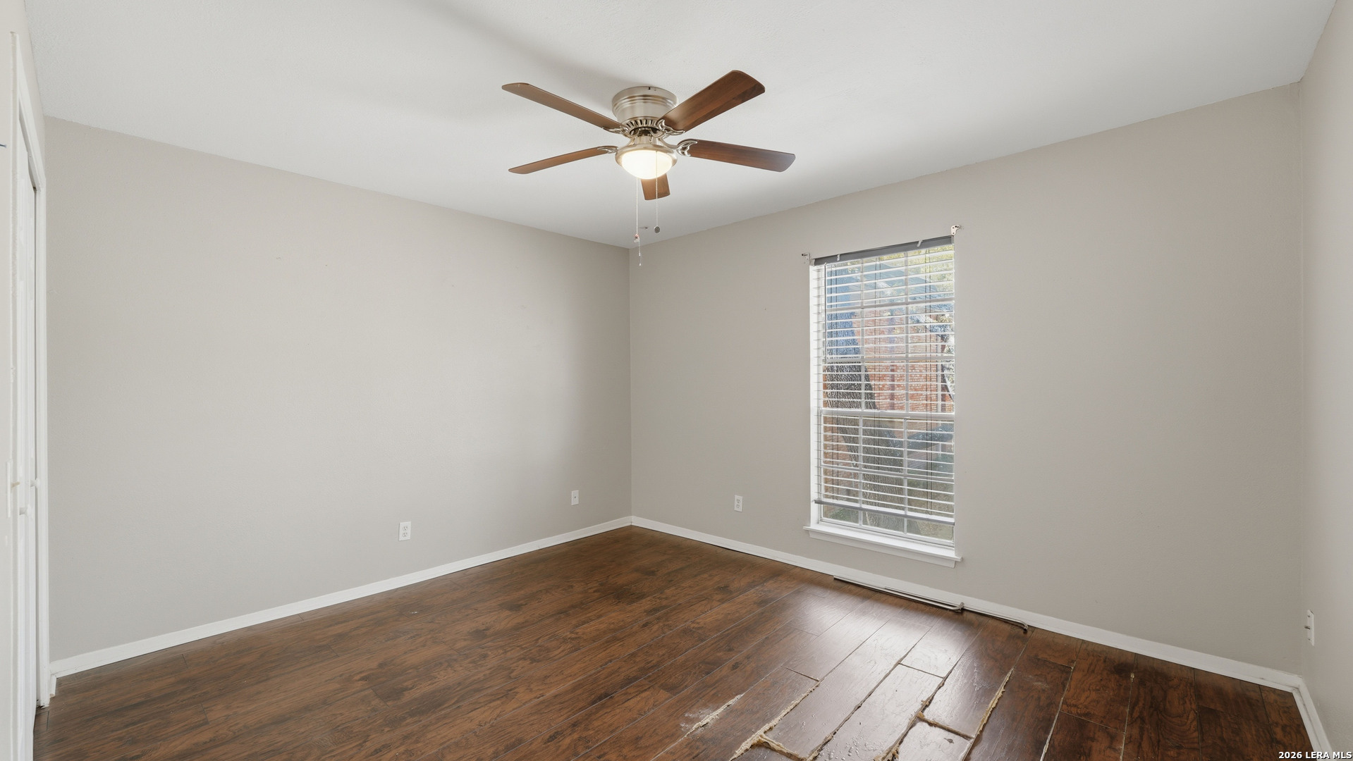 7500 Callaghan Road, Unit 140 San Antonio, TX 78229 - Photo 32 of 42 an empty room with wooden floor and windows
