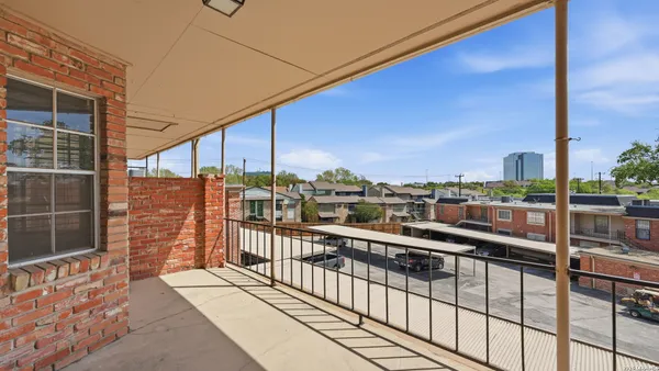 an aerial view of a house with roof deck and outdoor seating