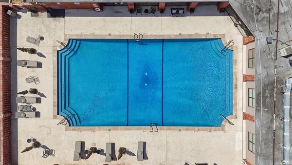 an aerial view of a house with swimming pool and sitting area