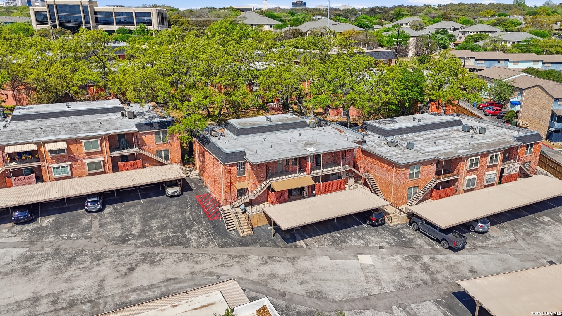 7500 Callaghan Road, Unit 140 San Antonio, TX 78229 - Photo 40 of 42 an aerial view of a house with balcony and trees al around