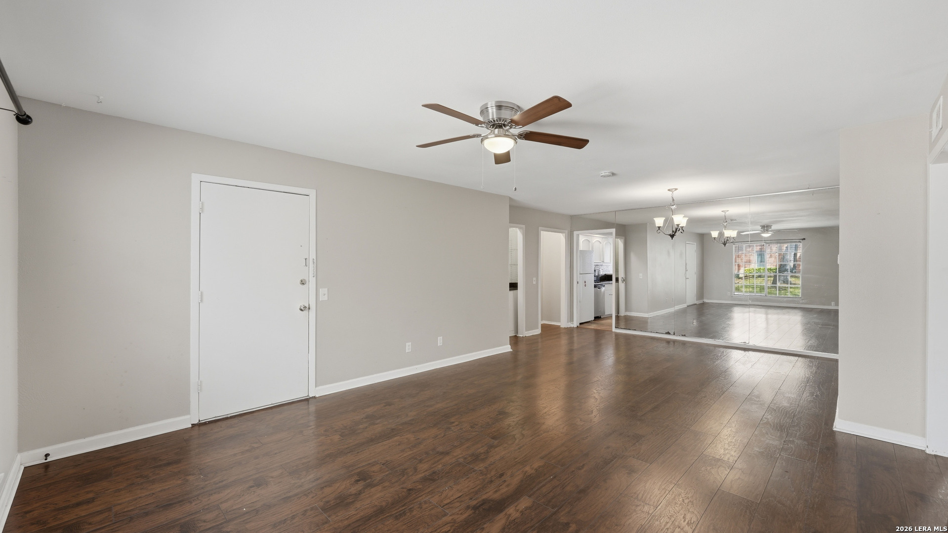 7500 Callaghan Road, Unit 140 San Antonio, TX 78229 - Photo 5 of 42 a view of empty room with wooden floor and ceiling fan