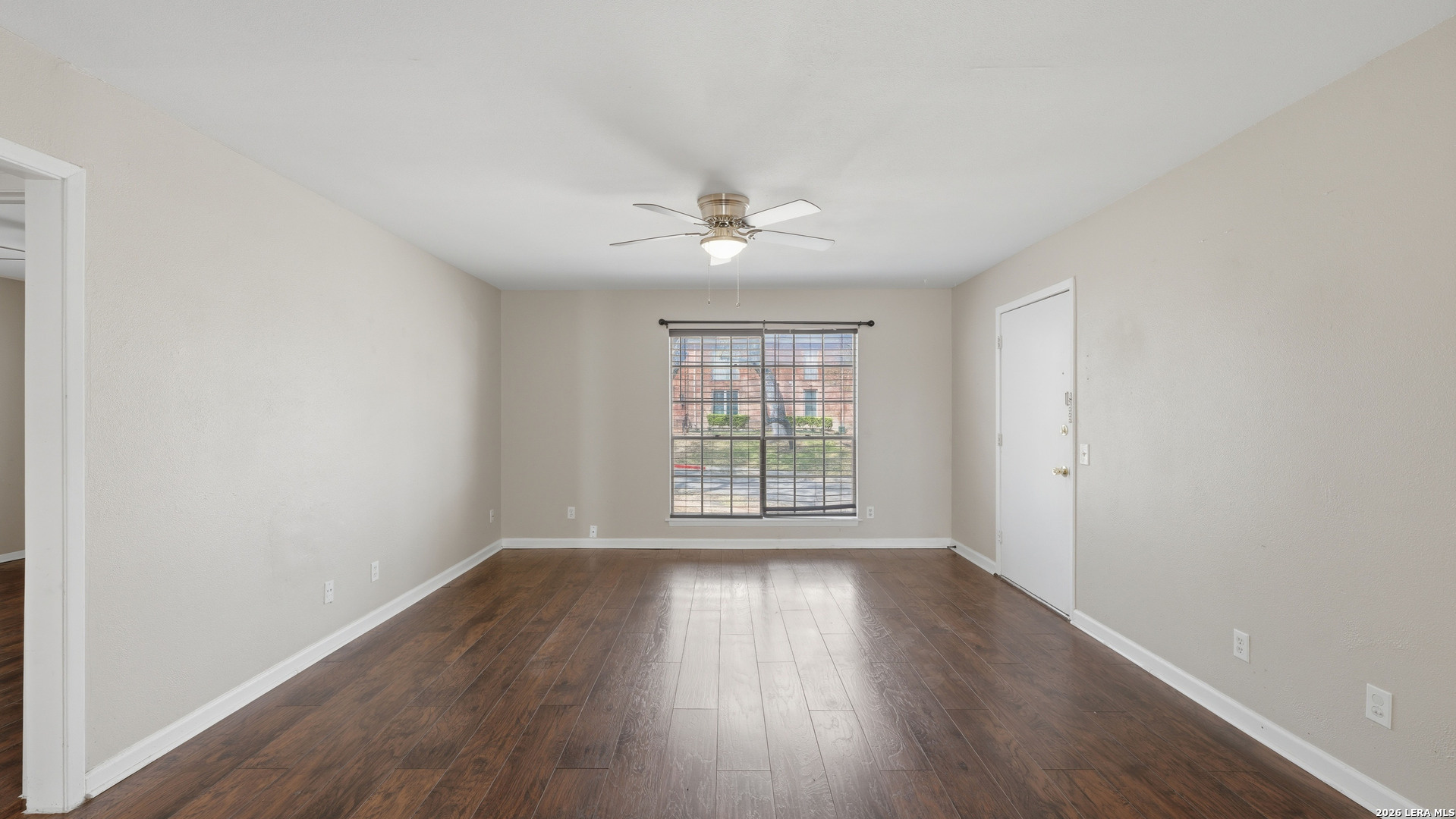 7500 Callaghan Road, Unit 140 San Antonio, TX 78229 - Photo 7 of 42 an empty room with wooden floor and windows