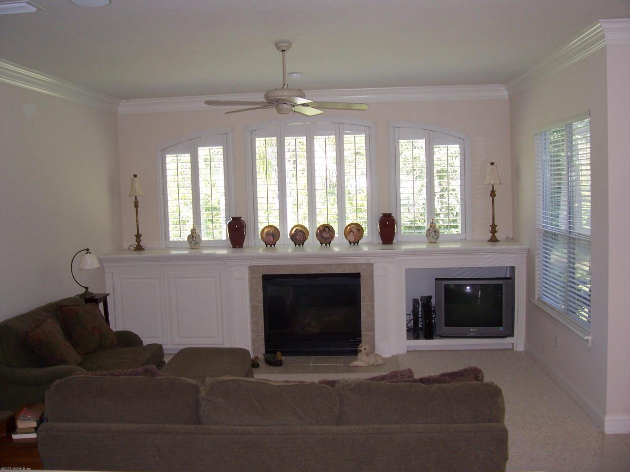 508 Fresh Pond Road Ponte Vedra Beach, FL 32082 - Photo 3 of 7 a living room with furniture a fireplace and a floor to ceiling window