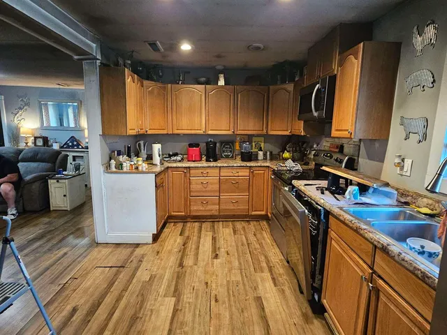 a kitchen with wooden cabinets and sink