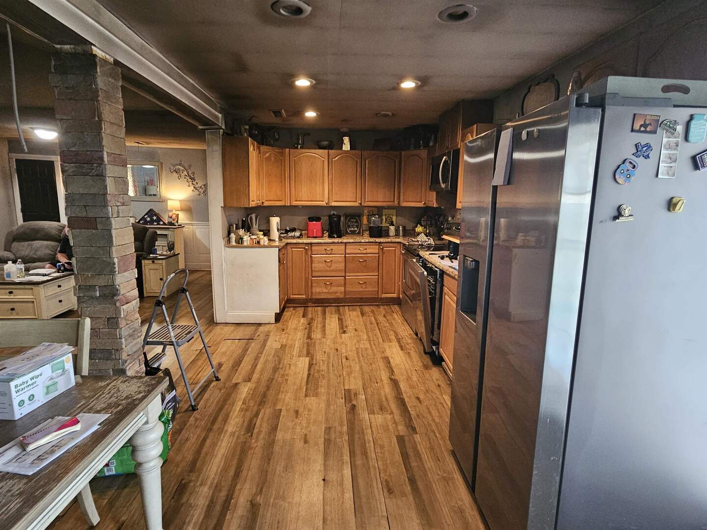 686 Airport Road Metropolis, IL 62960 - Photo 6 of 19 a kitchen with refrigerator a stove and wooden floor