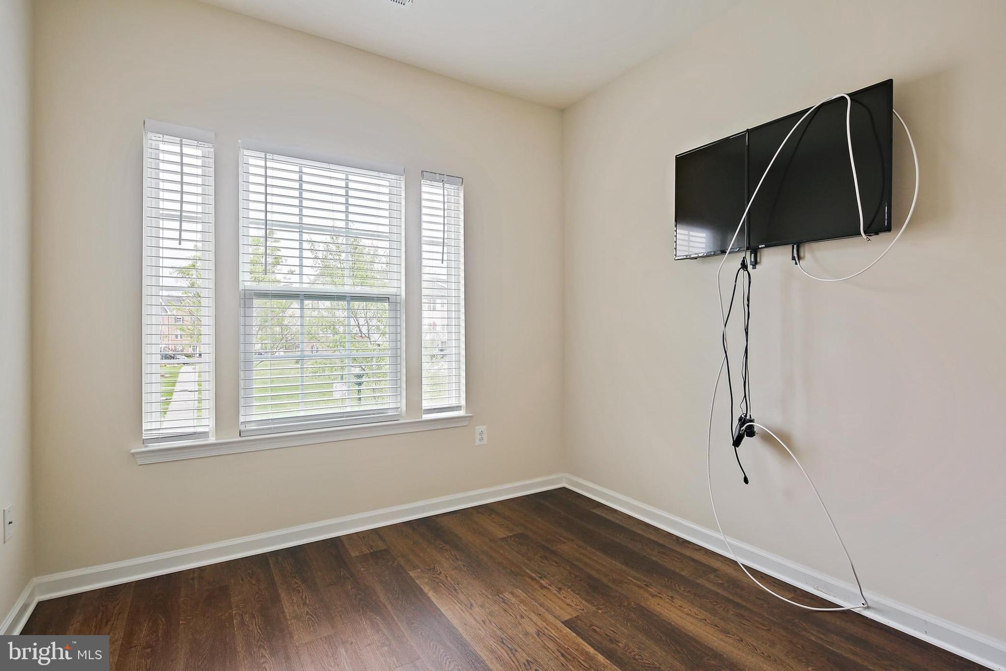 11675 Emerald Green Drive Clarksburg, MD 20871 - Photo 22 of 35 an empty room with wooden floor and windows