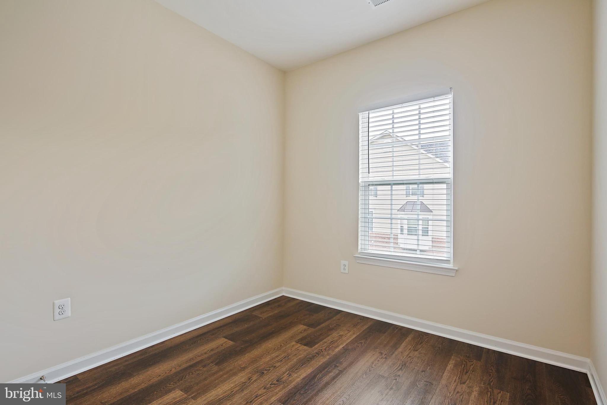 11675 Emerald Green Drive Clarksburg, MD 20871 - Photo 24 of 35 an empty room with wooden floor and windows