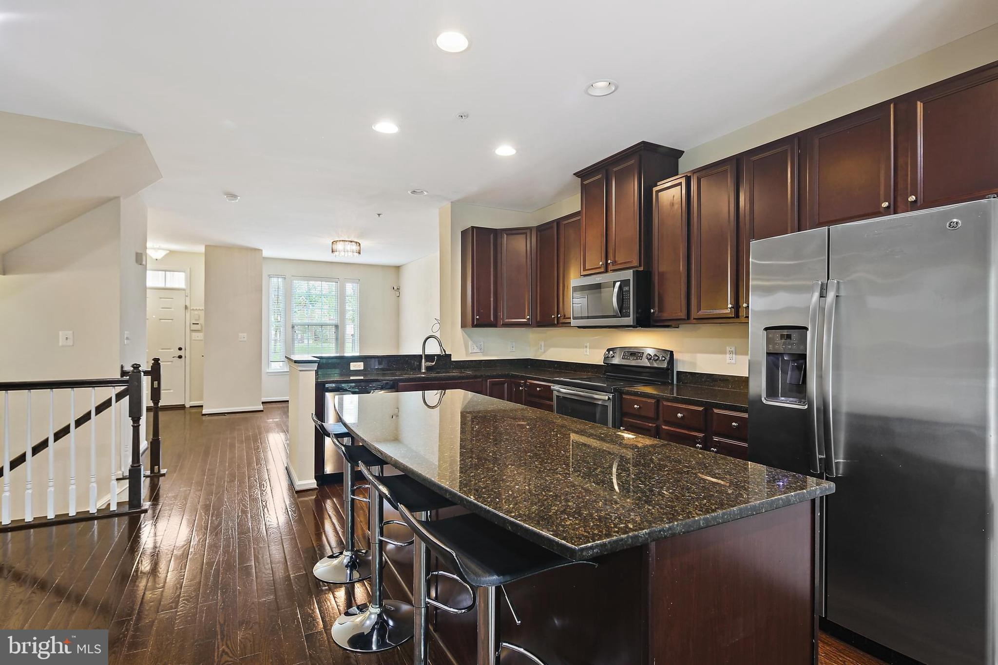 11675 Emerald Green Drive Clarksburg, MD 20871 - Photo 3 of 35 a kitchen with stainless steel appliances granite countertop a sink a stove and refrigerator