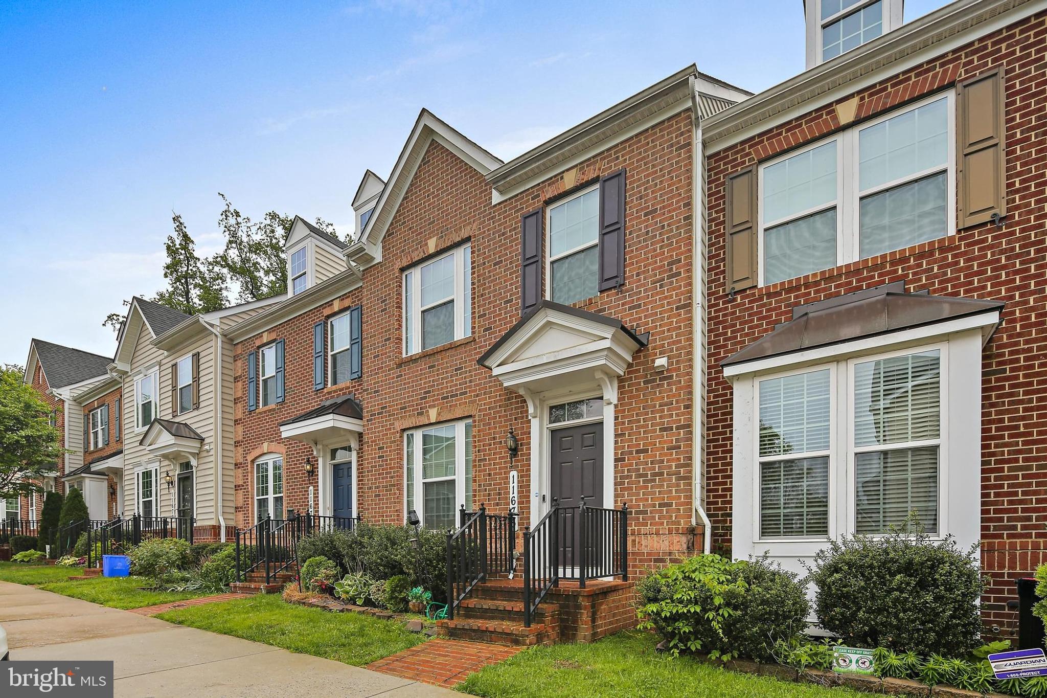 11675 Emerald Green Drive Clarksburg, MD 20871 - Photo 33 of 35 front view of a brick house with a yard