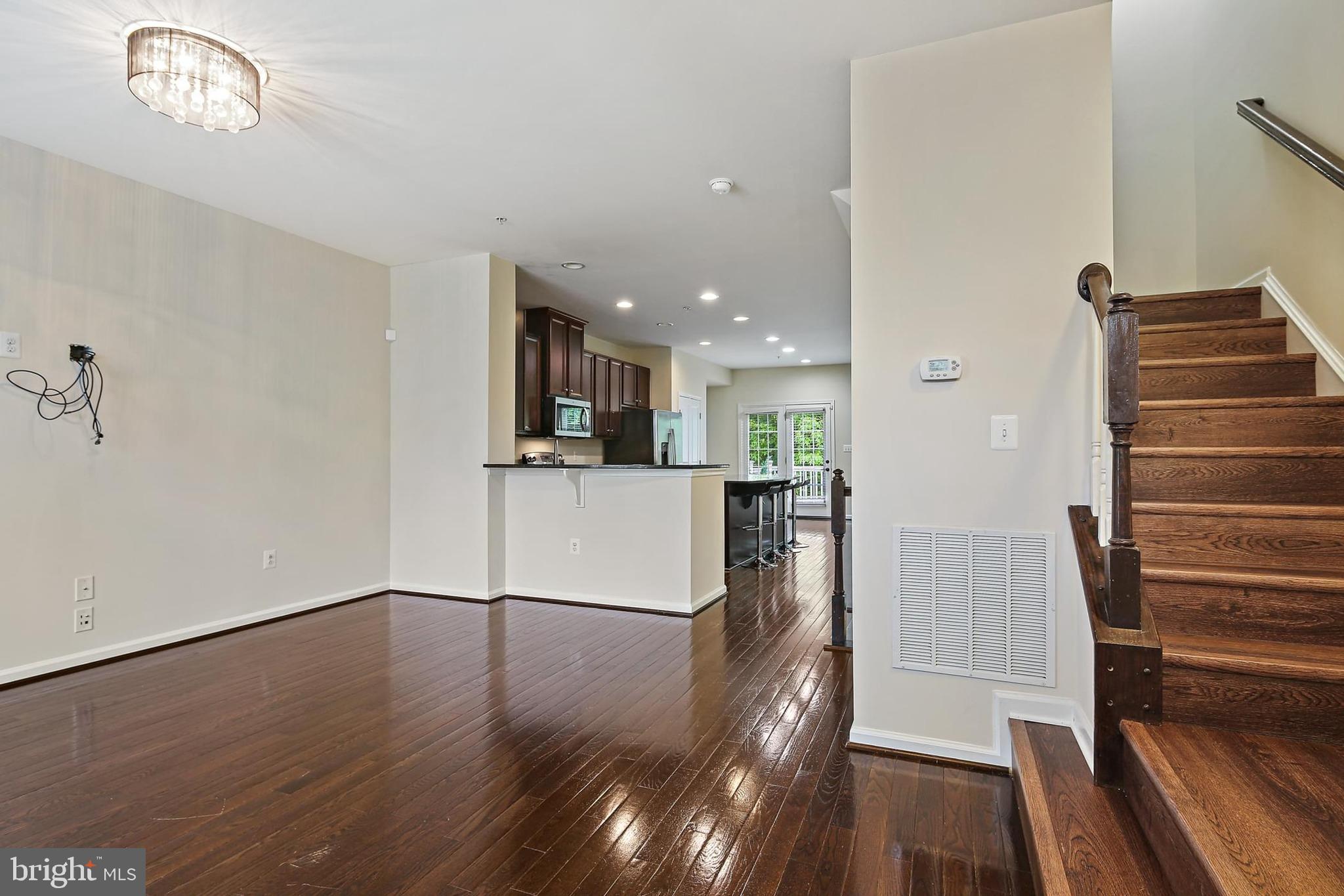 11675 Emerald Green Drive Clarksburg, MD 20871 - Photo 6 of 35 a view of a kitchen with wooden floor and electronic appliances